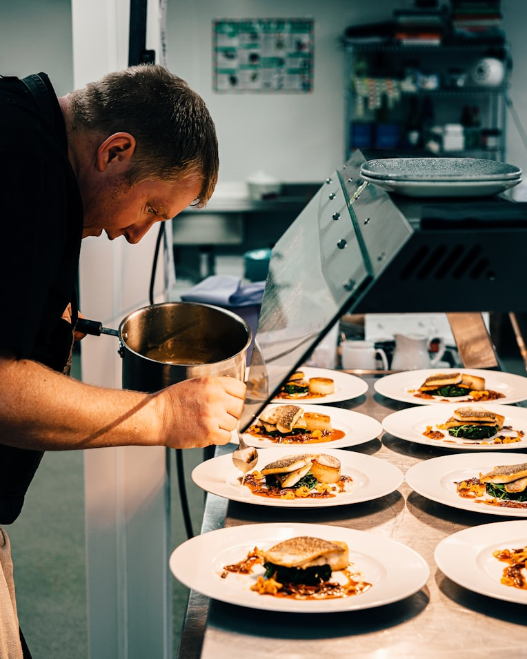 Chef meticulously plating a dish